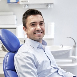 Man sitting up and smiling with dental implants in Lady Lake, FL