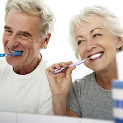 An older couple brushing their teeth in Lady Lake