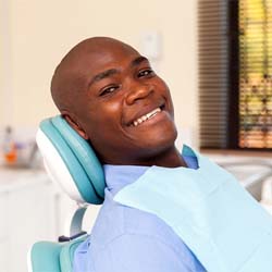 A young man lying back in a dentist’s chair preparing for a regular checkup in Lady Lake