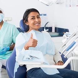 Patient giving thumbs up in dentist's treatment chair