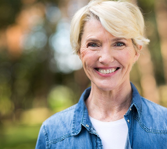 Woman smiling after gum disease treatment